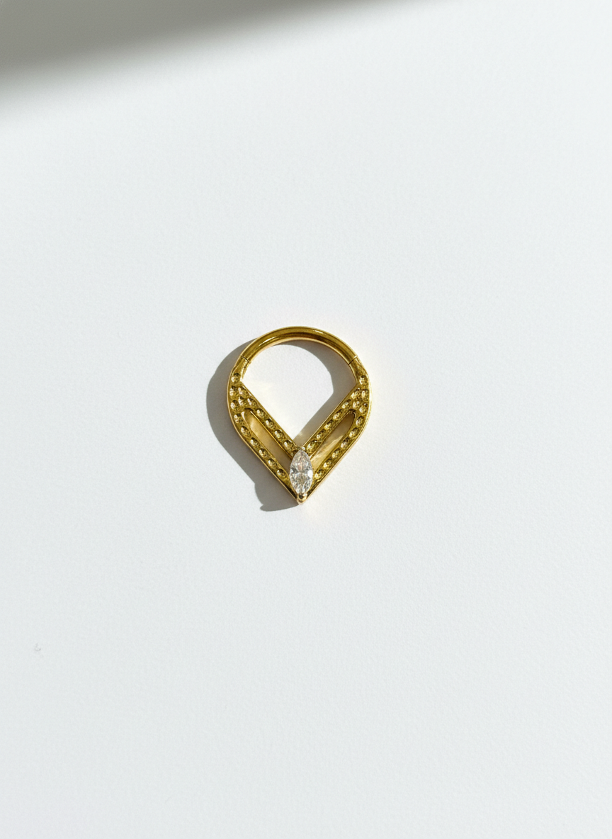 Piercing clicker titanio 16G, zirconia ovalada sobre triangulo - piercings Mundo Chic